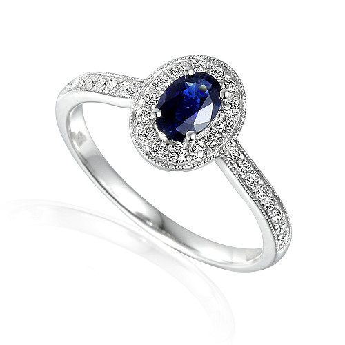 Claw Set Oval Cut Tanzanite With Micro Set Round Brilliant Diamond Halo And Shoulders Ring