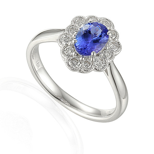 Oval Cut Tanzanite Claw Set With Micro Set Round Brilliant Cut Diamond Halo And Shoulders Milgrain Ring