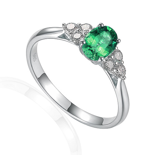 Oval Cut Emerald Claw Set With Round Brilliant Cut Diamond Trefoil Ring