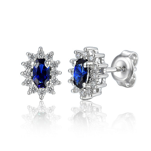 Claw Set Oval Cut Blue Sapphire And Round Brilliant Cut Diamond Cluster Earrings